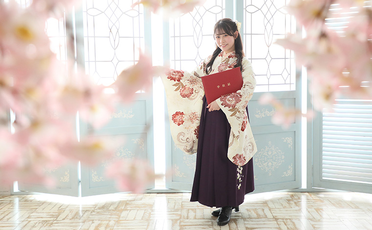 屋外でポーズをとる袴姿の女性